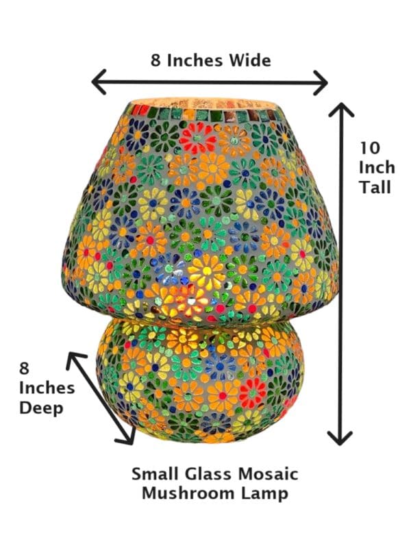 A large glass mosaic lamp with flowers on it.