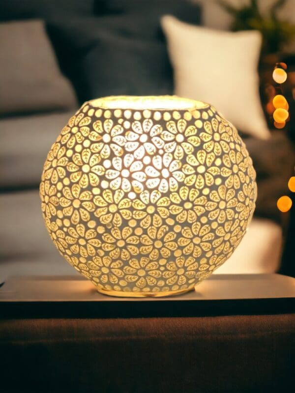 A table lamp with a white flower design on it.