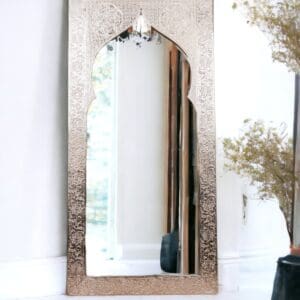 A mirror with a metal frame and a wooden arch.