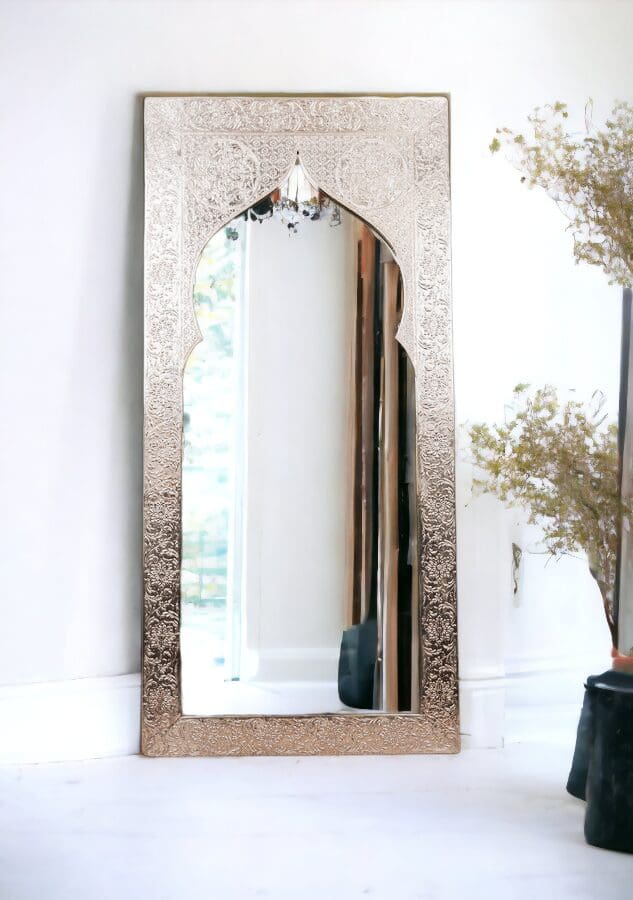 A mirror with a metal frame and a wooden arch.