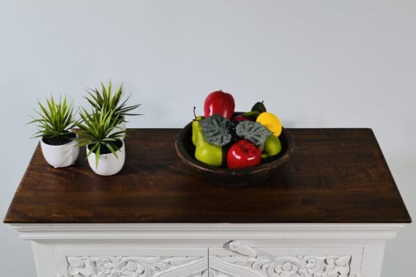 A bowl of fruit on top of a table.