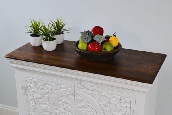 A bowl of fruit on top of a table.