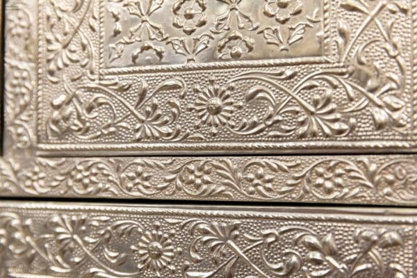 A close up of the ornate metal work on this box