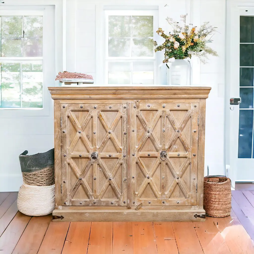 A hand-crafted solid mango wood sideboard sitting on top of a hard wood floor.