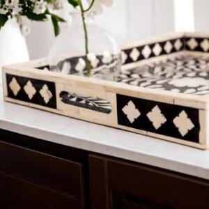 A tray with black and white design on top of a counter.