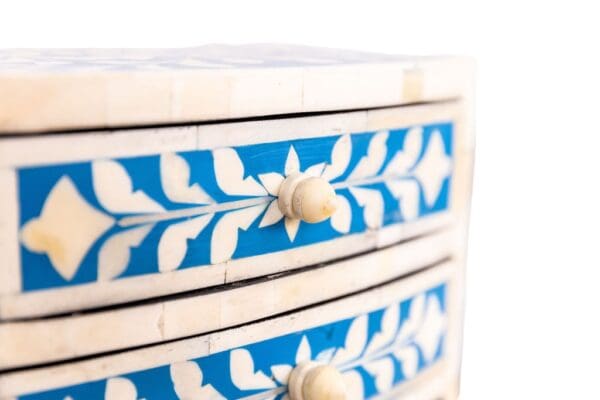 blue and white four drawer jewelry box on a white background