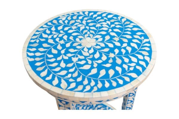 Blue and white side table in hand-crafted bone inlay on a white background