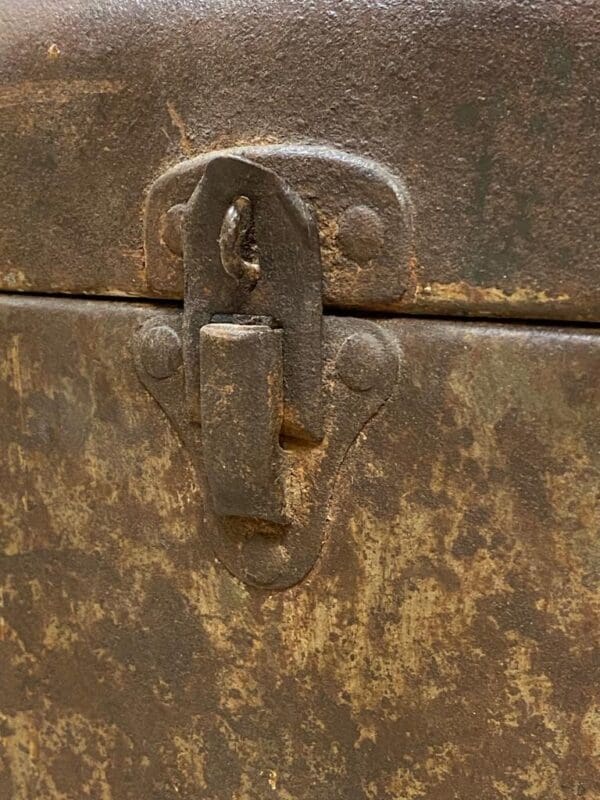 A close up of the lock on an old metal box