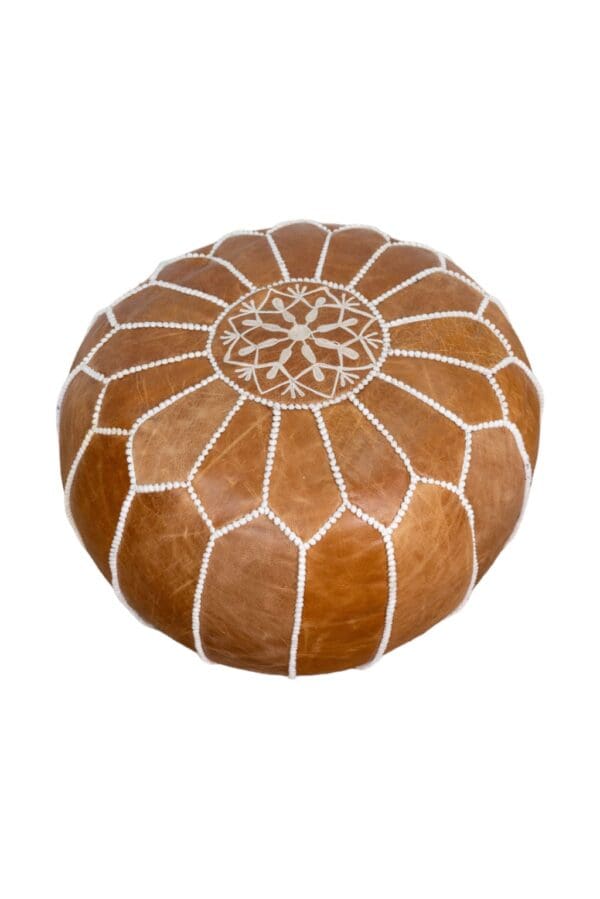 hand-crafted soft leather footstool on a white background