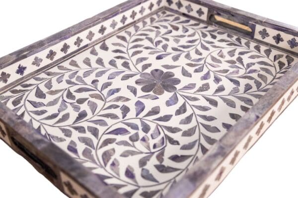 gray and white decorative tray with a floral patten on a white background