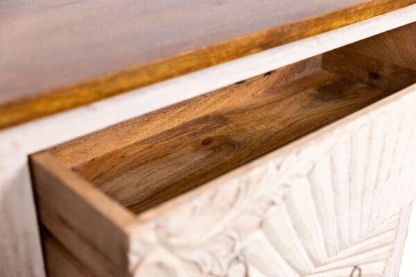 hand-carved four-drawer dresser on a white background