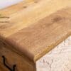 A wooden box with a carved lid on top of it.