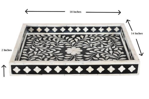 A black and white tray with a floral design.