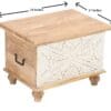A wooden trunk with a white design on the front.