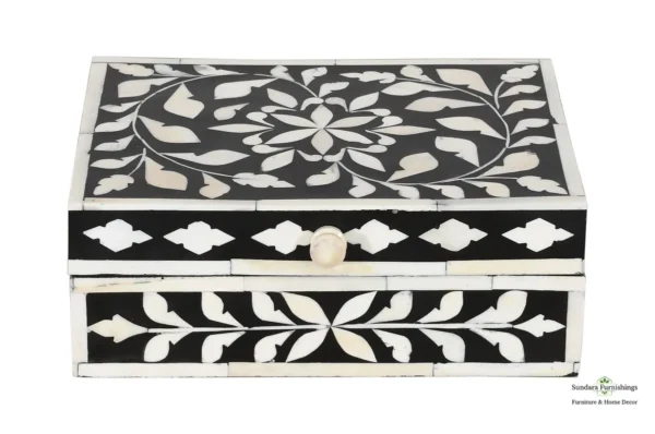 A black and white box with a floral design.