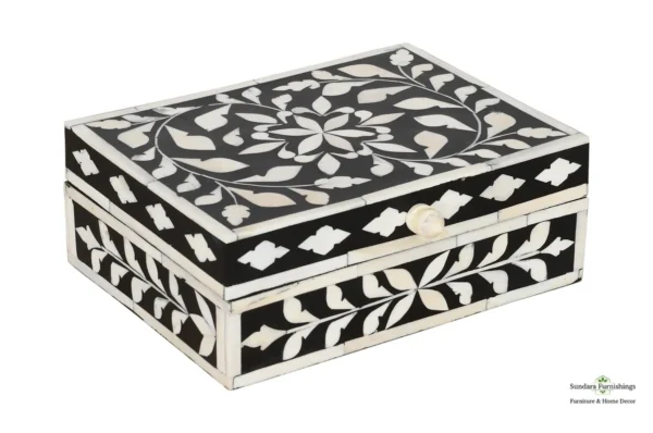 A black and white box with floral design.