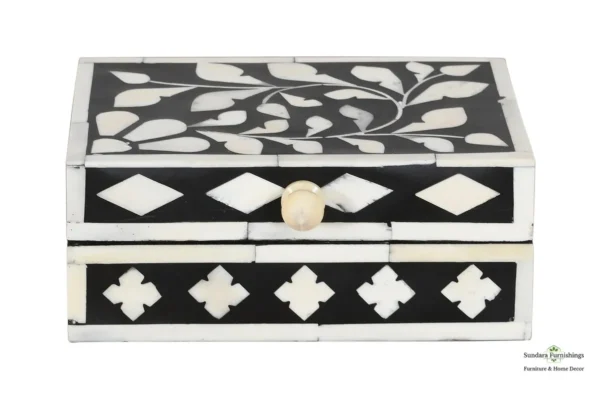 A black and white box with a floral design.