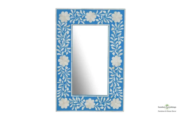 A mirror with blue and white floral design.