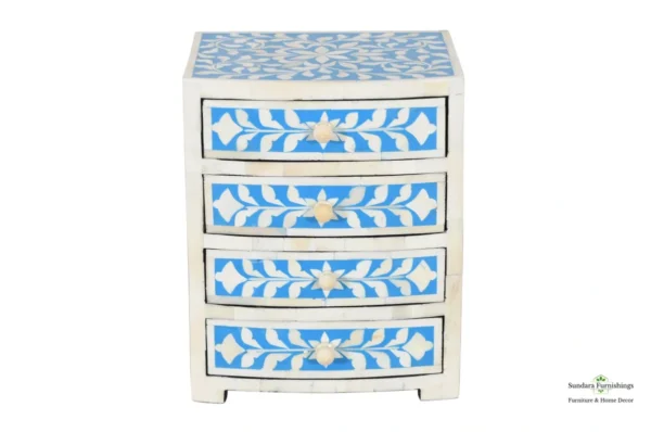 A blue and white chest of drawers with four drawers.