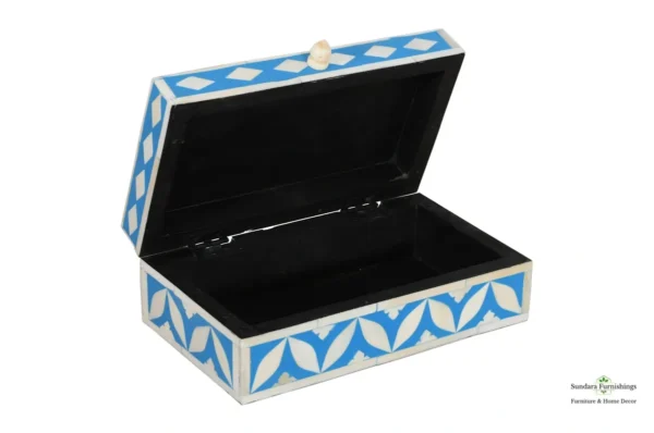 A blue and white box with a black lid.