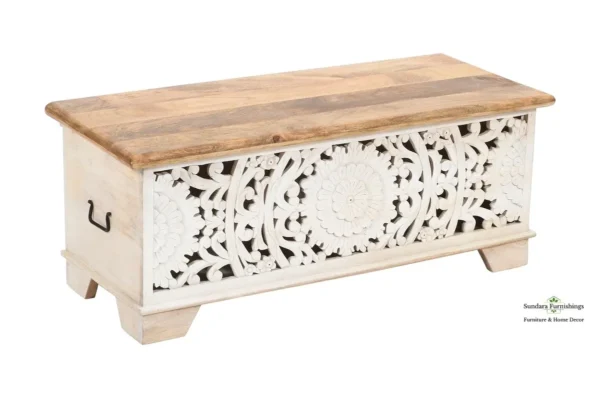 A wooden box with a white floral design on it.