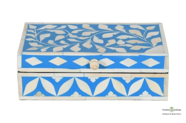 A blue and white box with a wooden handle.