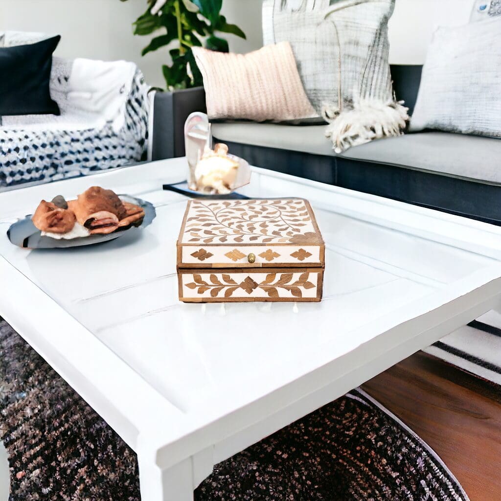 A white table with a wooden box on top of it.