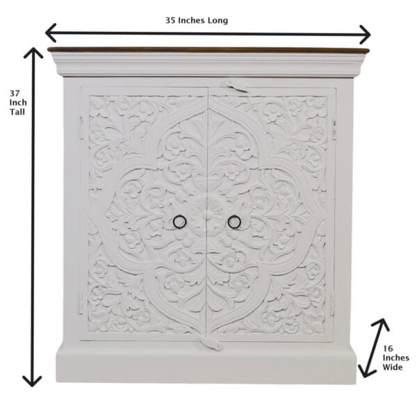 A white cabinet with two doors and a large leaf design.