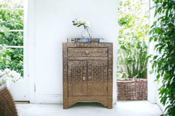 White metal side table staged by a bright sunny window.