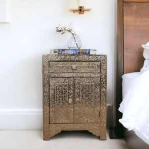 Stunning white metal side table, hand embossed with 1 drawer and 2 doors. Staged in a bedroom as a nightstand