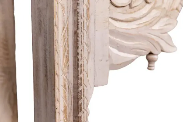 whitewashed carved console table on a white background