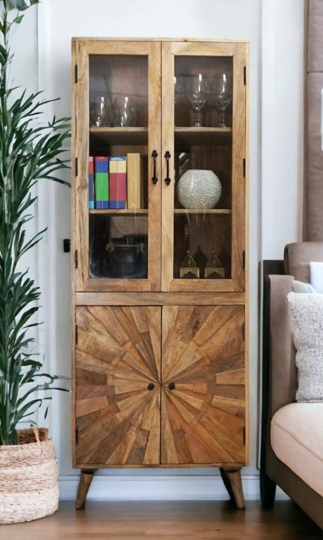 A wooden cabinet with glass doors and a plant in the corner.