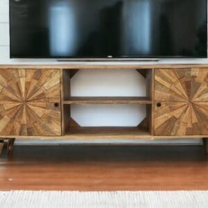 hand-crafted sunburst design tv unit staged in a living room