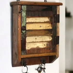 Rustic farmhouse-style key cupboard staged hanging on a white wall with keys in a home