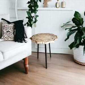 Hand-crafted mango wood mandala accent table staged in a living room