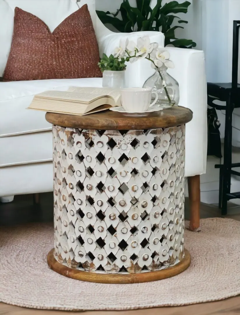 whitewashed wood lattice side table with a natural top staged in a living room