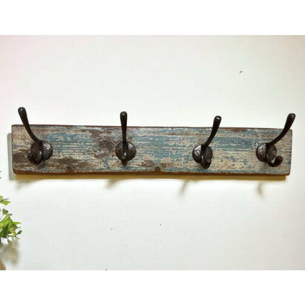 Rustic wooden coat rack with four hooks.