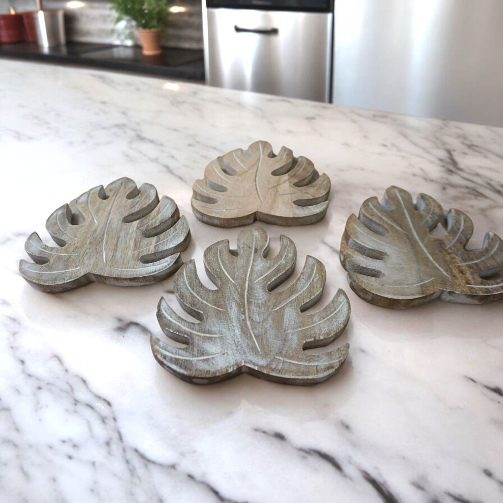 set of 4 hand-crafted wooden leaf trivets / large coasters / pot holders staged in a kitchen