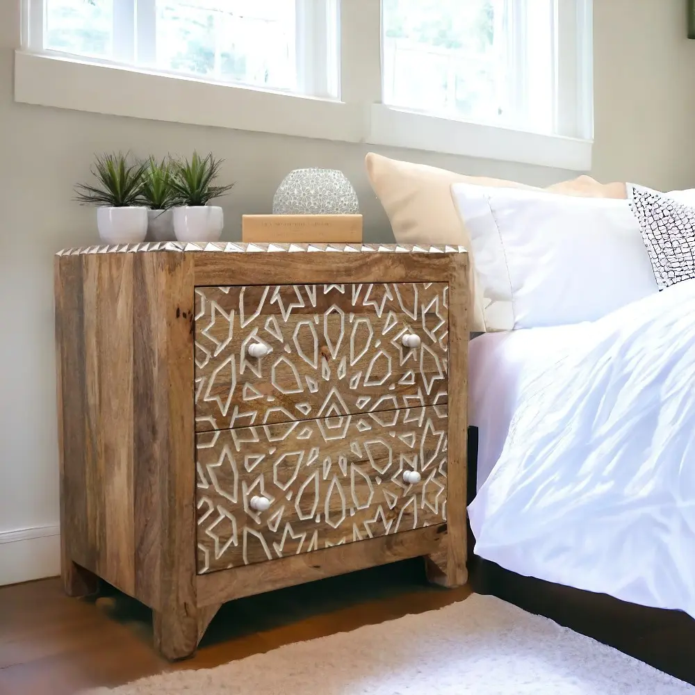 hand0crafted mango wood nightstand with two drawers with a geometric pattern staged in a bedroom