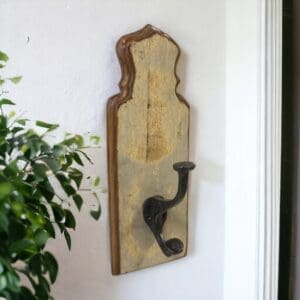 Single hook coat rack made of reclaimed wood hanging on a wall