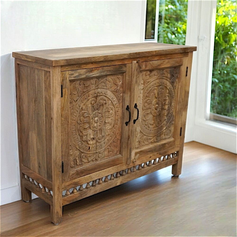 Natural mango wood sideboard, with hand-carved details, staged in a sunny home