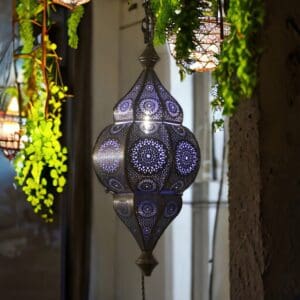 Moroccan hanging lantern lit staged at night in a home