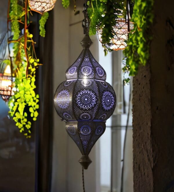 Moroccan hanging lantern lit staged at night in a home