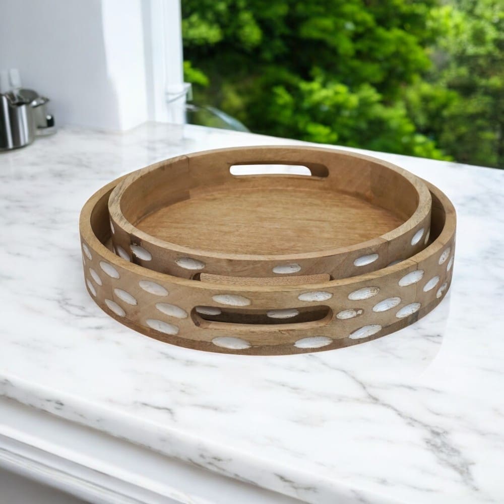 Set of two round wooden serving trays staged in a kitchen