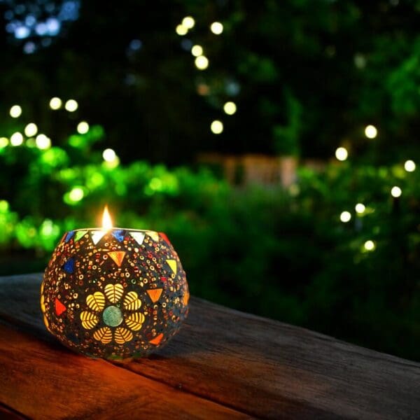 3,5 inch round candle holder staged in a garden at night