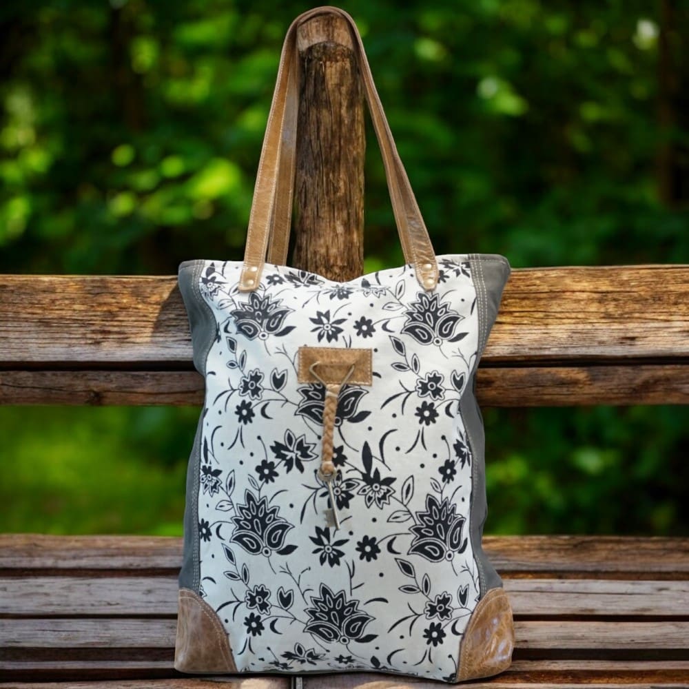 Cotton canvas sage green tote bag with floral front panel, leather accents and straps