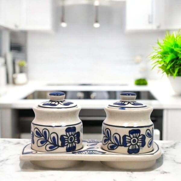 Hand-crafted traditionally used as Indian pickle or chutney jars this hand-painted set of two ceramic pots with lids and matching ceramic tray is a versatile addition for any home.