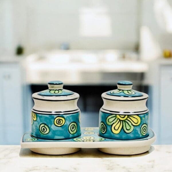 Hand-crafted traditionally used as Indian pickle or chutney jars this hand-painted set of two ceramic pots with lids and matching ceramic tray is a versatile addition for any home.