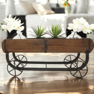 Handcrafted vintage double brick molds reimagined as a trolley with wheels stages on a living room table with plants inside