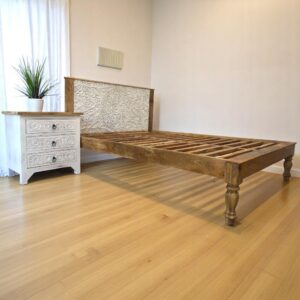 Hand-crafted solid natural mango wood queen bedframe with whitewashed center panel in a sunny bedroom